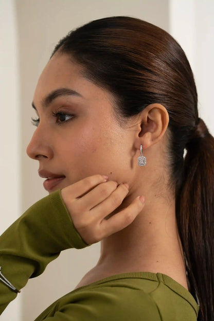 High-resolution close-up of a diamond hoop earring with geometric drop pendant, luxury jewelry style