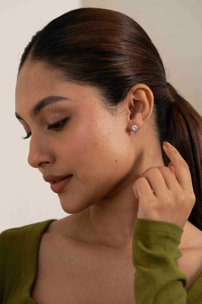 Macro shot of a sparkling diamond stud earring on ear, showcasing fine jewelry craftsmanship