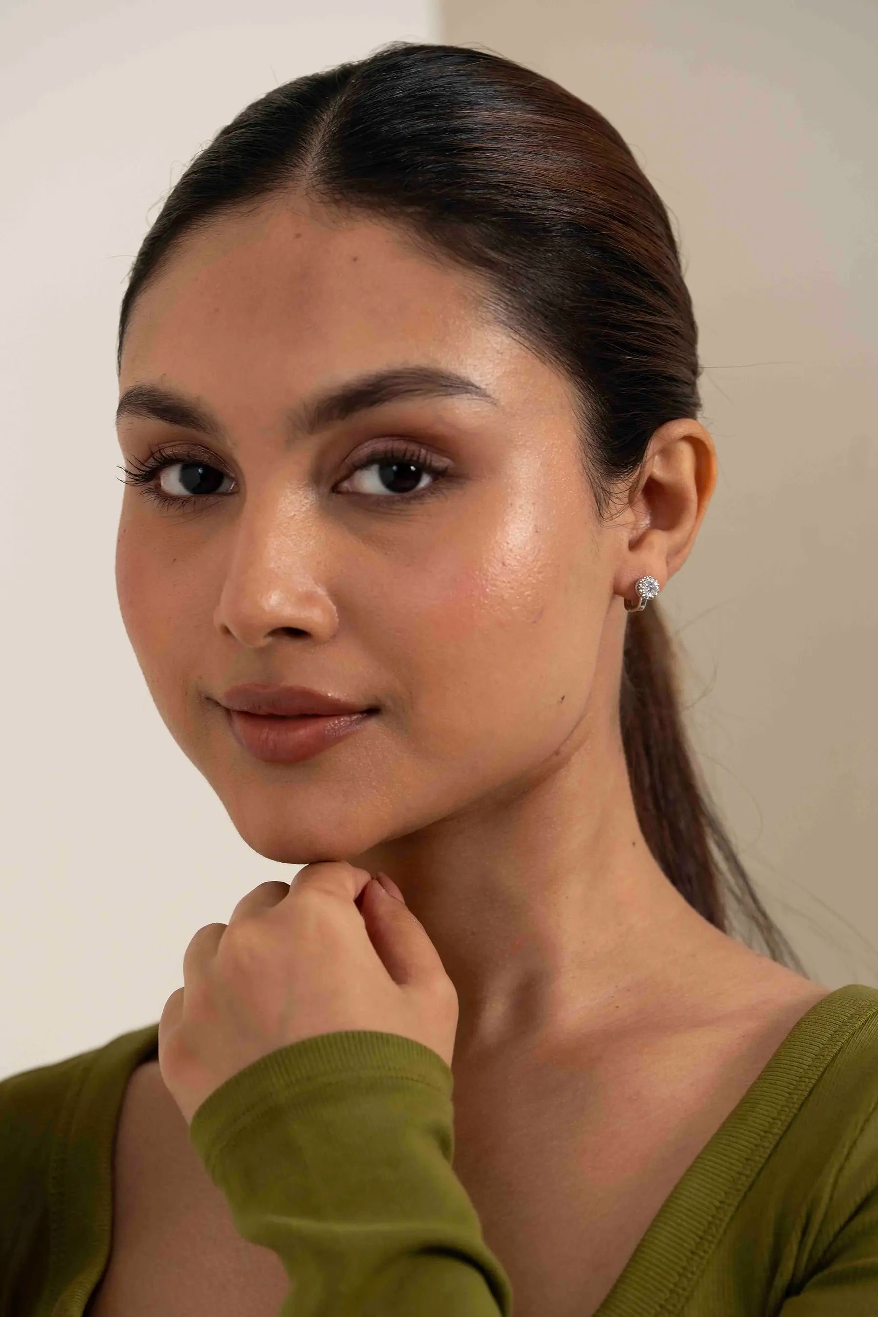 Elegant halo diamond stud earring on a woman’s ear, luxury everyday jewelry accessory