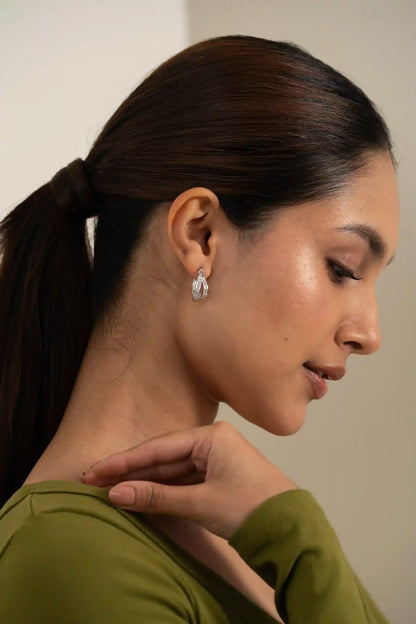 Elegant diamond hoop earring with channel-set baguette stones, close-up fashion jewelry detail