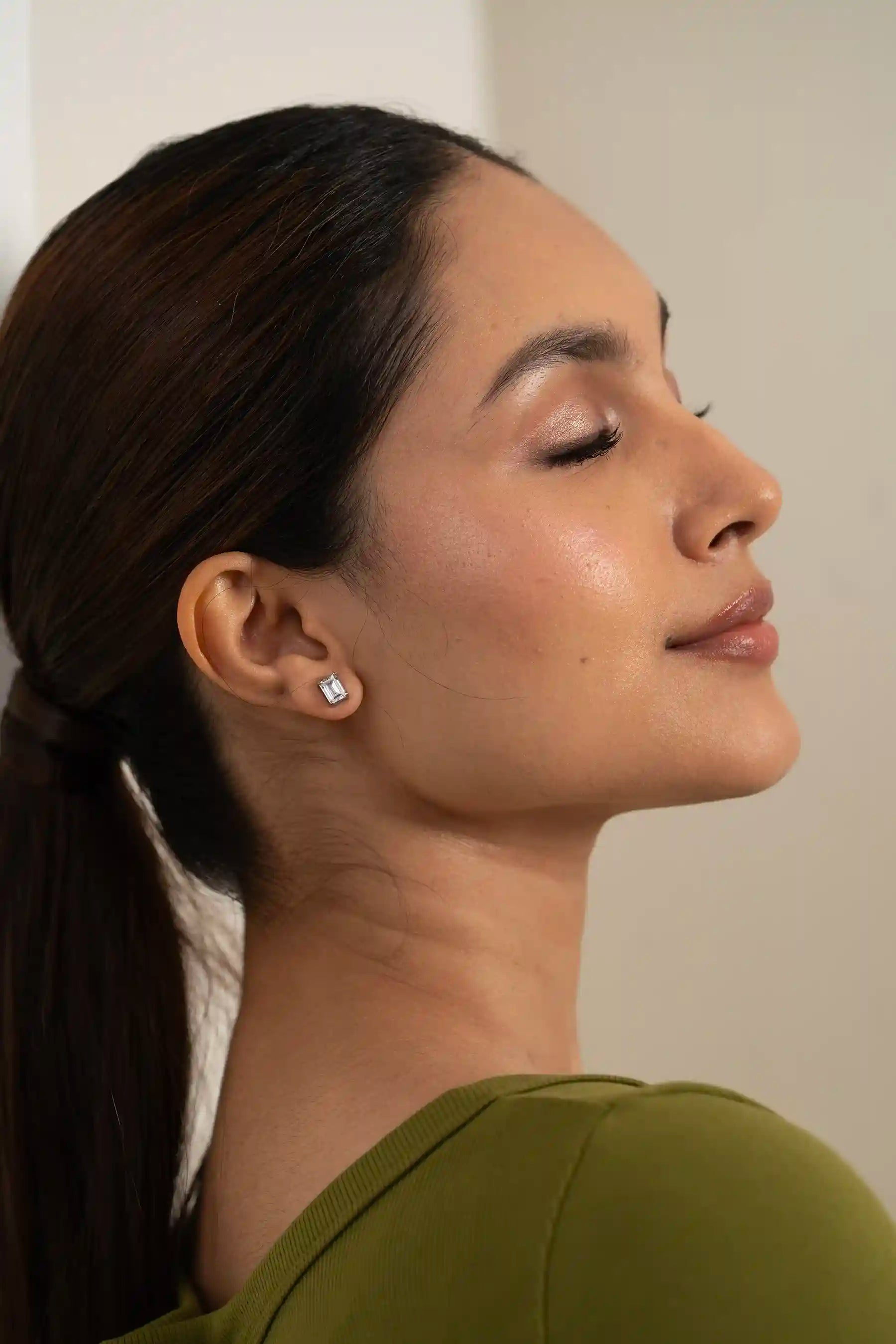 High-resolution close-up of a rectangular diamond stud earring, classic luxury accessory