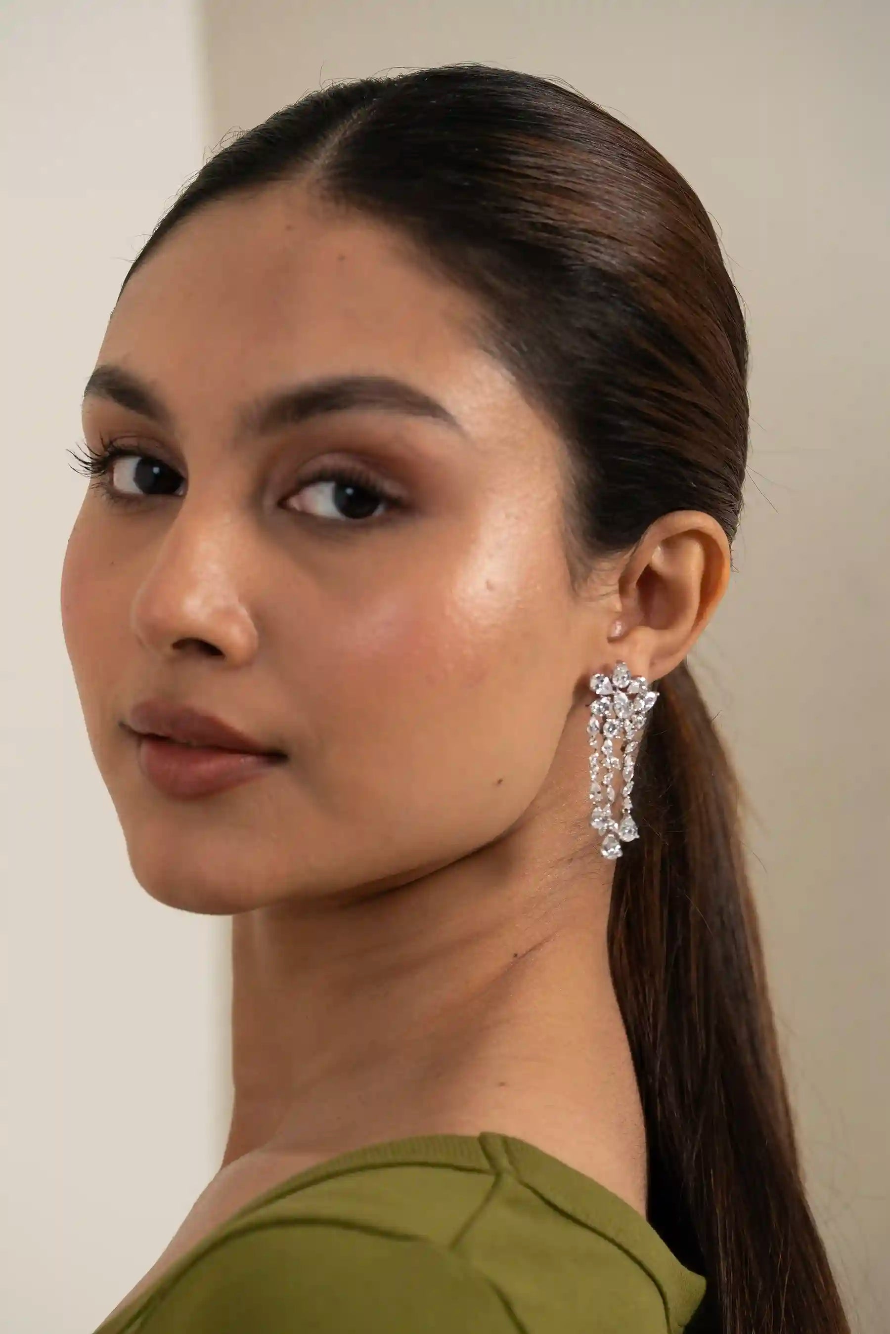 Elegant diamond drop earring with floral cluster and long dangling strands, luxury jewelry close-up