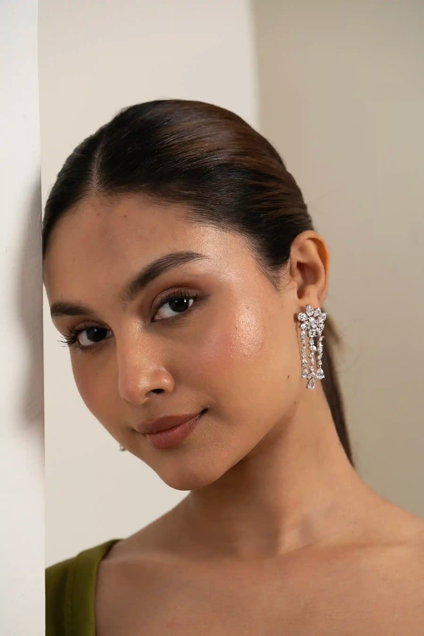 Close-up of a statement diamond chandelier earring with multiple dangling layers, glamorous jewelry design