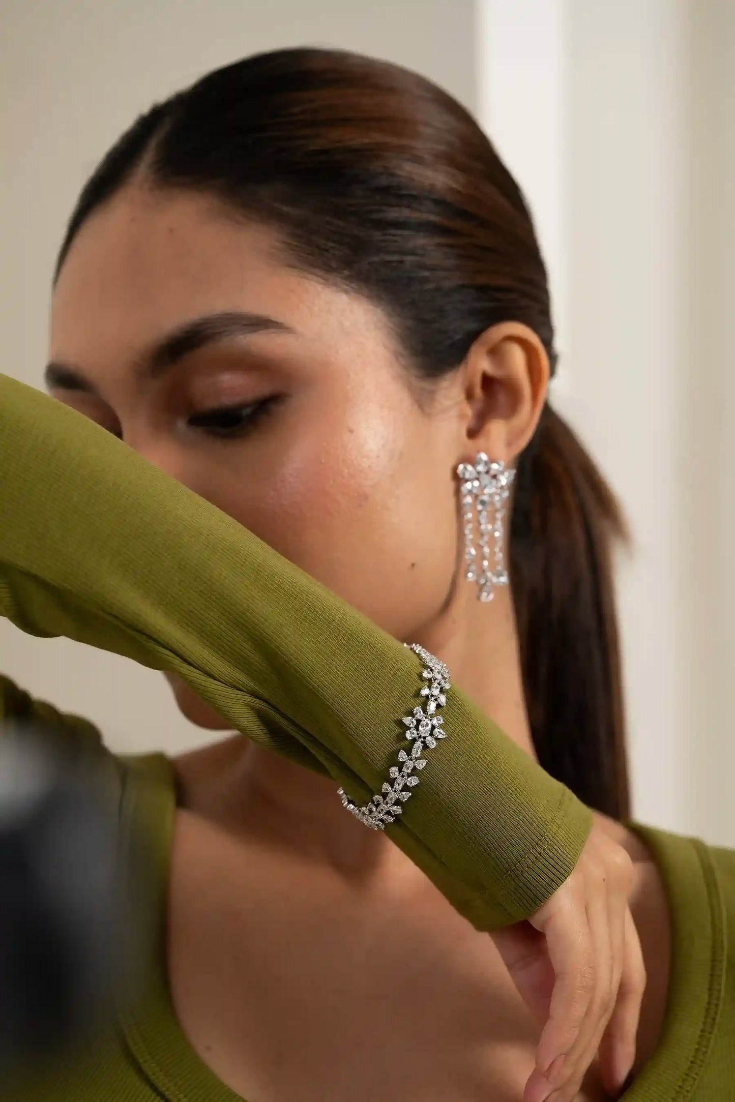Diamond bracelet with continuous daisy motif, sparkling cluster design on wrist, minimal editorial look