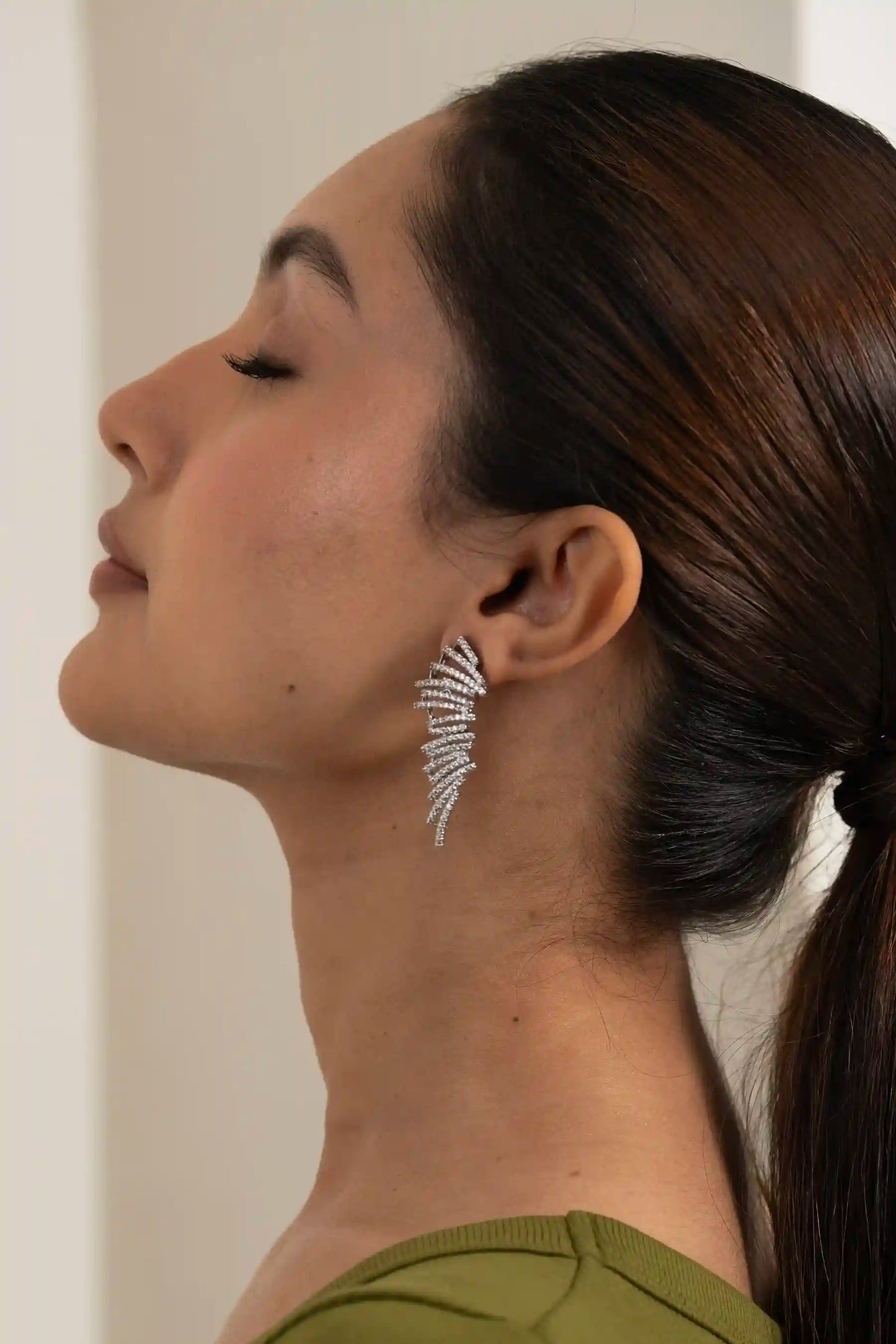 Luxury feather-inspired ear climber earring with fine diamond detailing, modern handcrafted demi-fine jewellery
