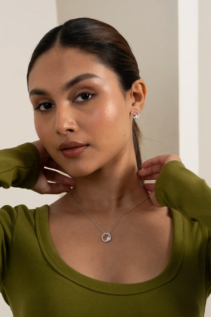 Close-up of open circle diamond pendant necklace with cluster detailing on delicate chain