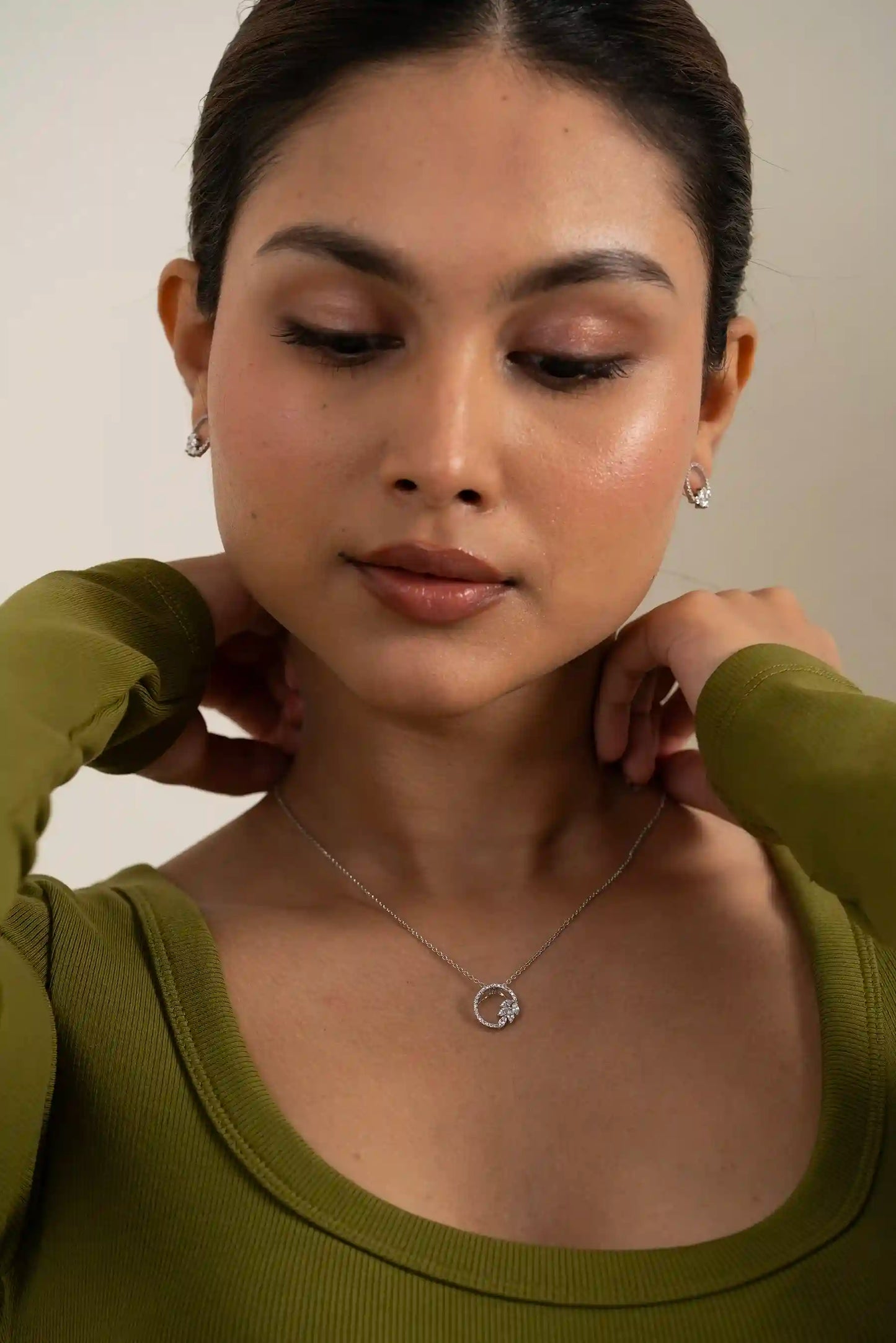 Minimal diamond circle pendant necklace with matching earrings styled for everyday elegance