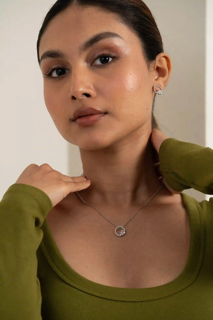 Open circle diamond jewellery set with cluster studs styled on model in neutral studio background