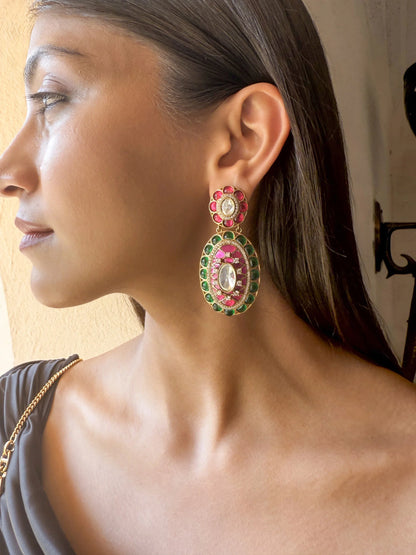 High-end ethnic fashion look with a woman in a gold outfit styled with statement earrings and ring
